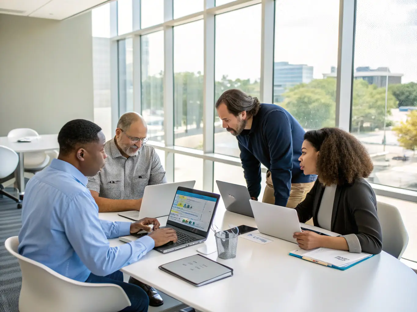 An image showcasing a team of consultants working on a digital transformation strategy with a client, using tablets and interactive displays to visualize data and plan the transformation process.